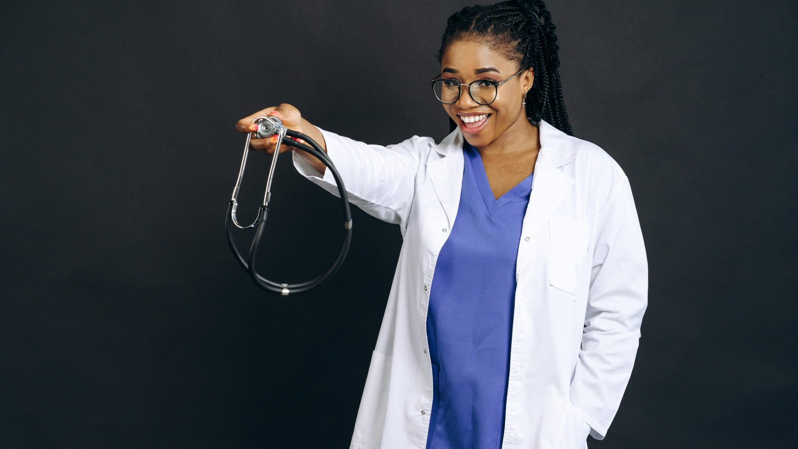 A Black female GP in conversation with a mature patient during a routine consultation